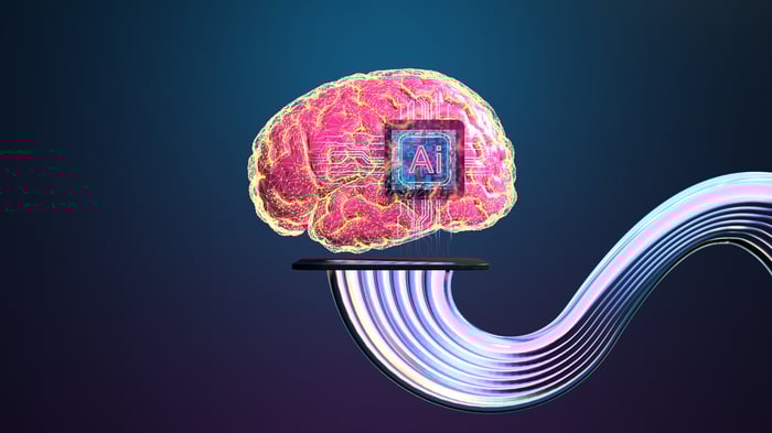 Мозок з чіпом, позначеною AI всередині нього, і кабелі, що проходять з його нижньої частини.