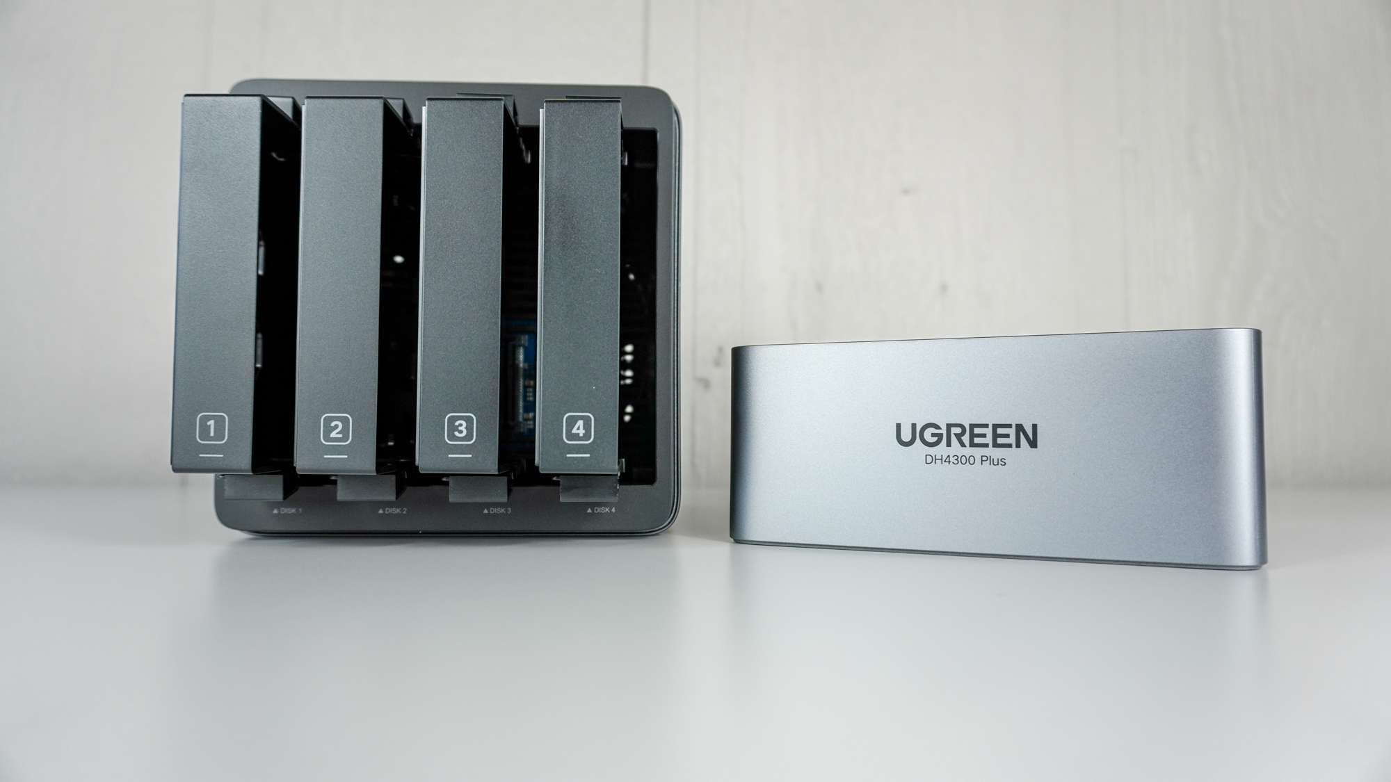 Ugreen NASync DH4300 Plus із відкритим магнітним верхом і видимими чотирма корпусами відсіку для дисків